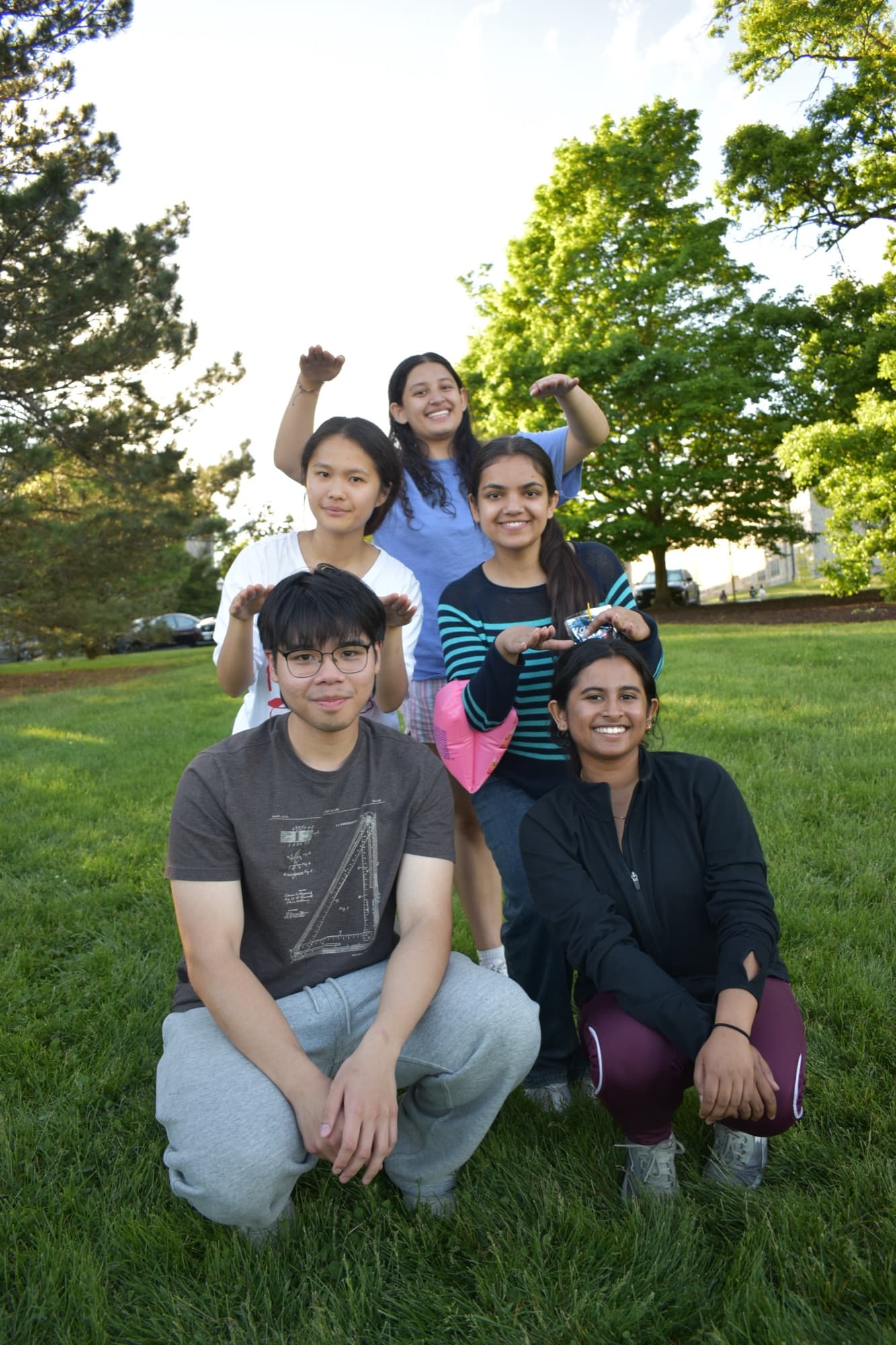 SASE members posing together in a stacked group on the lawn