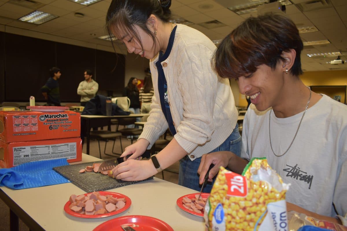 Two SASE members cooking together at a chapter food event