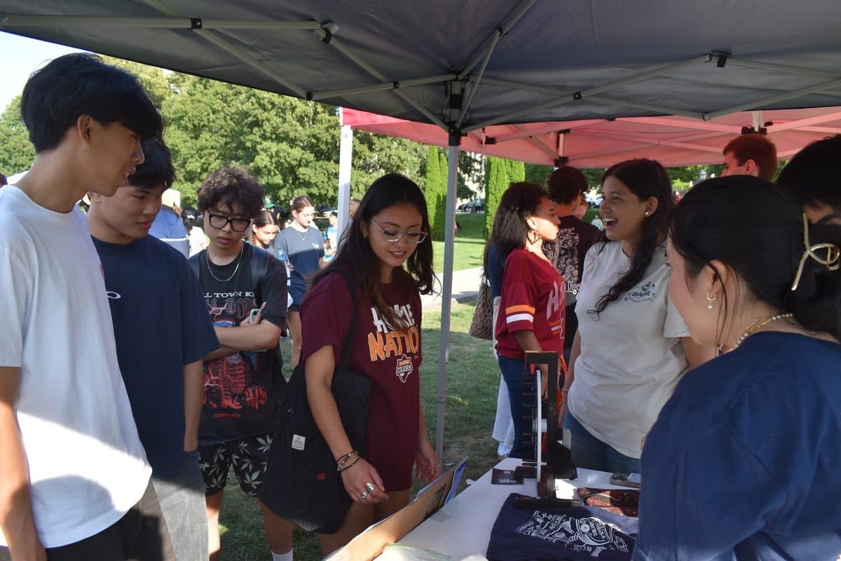 SASE members talking with students at an outdoor involvement fair
